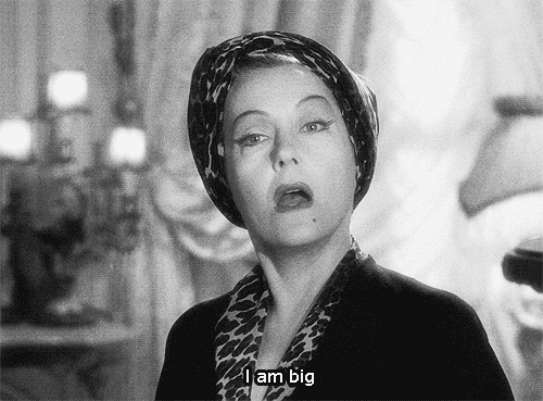 Movie gif. Gloria Swanson as Norma Desmond in Sunset Boulevard lifts her thin eyebrows up high and widen her eyes with confidence as she says, “I am big.”