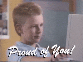 Video gif. A young boy stares at a computer before looking up and nodding while giving us a proud, half smile and a thumbs up. Text, "Proud of You!" 