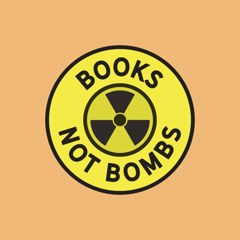 Digital art gif. Yellow circle with a rotating black nuclear fallout symbol inside. A red line shoots through the symbol, which then morphs into a book. Black text around the outside of the yellow circle reads, "Books not bombs," all against a light orange background.