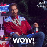 Sponsored gif. Man sits in a lawn chair with a beer in his hand. Text reads, “Wow!” In the upper right corner is the logo for AMC's Halfway to Halloween Month, streaming on Shudder.