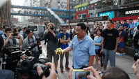 Man Opposing Protest Throws Yellow Ribbons in Anger