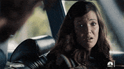 TV gif. Mandy Moore as Rebecca in This Is Us. She's sitting in the driver's seat of a car and looks around before grimacing and looking sorry.