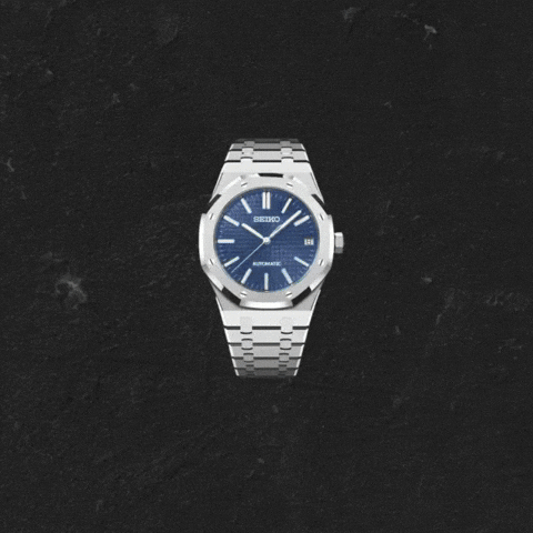 Silver-tone wristwatch with a blue dial, centered on a black textured background.