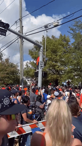 Astros Fan Climbs Onto Traffic Light Pole During World Series Parade in Houston