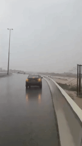 Rain Cascades Down Rockface as Cyclone Shaheen Hits Oman