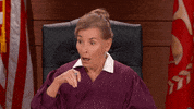 TV gif. In disbelief, a stunned Judge Judy shakes her head.