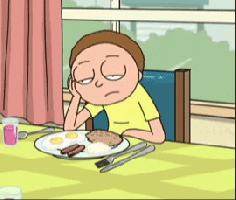 Cartoon gif. An exhausted Morty on Rick and Morty nods off at the breakfast table, falling face-first into a plate of eggs, sausage, and grits.