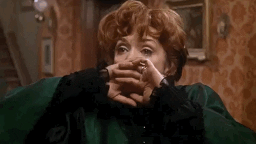 Movie gif. Close up of a woman with her hands over her mouth trying to protect herself. She closes her eyes and falls over backwards onto the floor like she has fainted or died. 