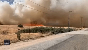Plane Drops Retardant Over Wildfire Burning in California's Riverside County