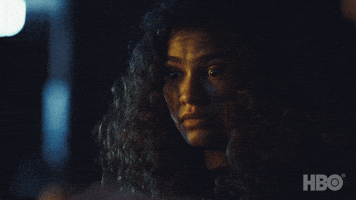 TV gif. Zendaya as Rue on Euphoria looks down at something with wide, nervous eyes. She looks out of the corner of her eye without barely moving her body.