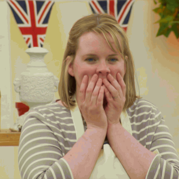 TV gif. A young female contestant from The Great British Baking Show covers her mouth in shock.