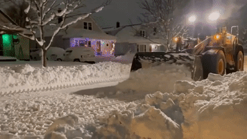 Plow Shifts Large Amounts of Snow After Blizzard