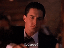 TV gif. Kyle MacLachlan as Dale in Twin Peaks raises his bottle to someone off screen as he looks at them seriously and says, "Godspeed."