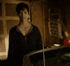 Celebrity gif. Morena Baccarin gazes, then unzips her hoodie seductively.