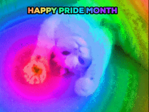Video gif. Cat lays upside and looks up at us as he flexes his two front paws in and out of fists. Out of his paws shootout rainbow rays of light that covers everything we see. Text, “happy pride month.”