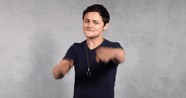 Celebrity gif. Arturo Castro throws his hands down and clenches his jaw, acting upset.