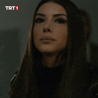 TV gif. Deniz Baysal as Zehra in Teşkilat. She cheers, jumps, and claps eagerly as she eats.