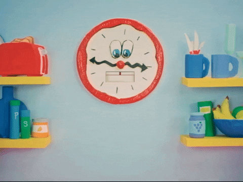 Digital illustration gif. Red clock with a mustachioed face on the wall next to yellow shelves and kitchen items looks down at text that pops into frame, "Rise and shine!'