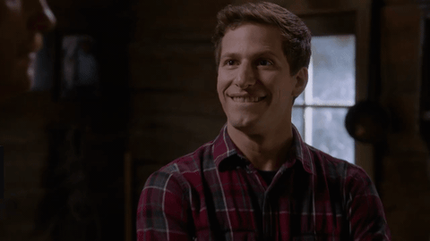 Celebrity gif. Andy Samberg has a sarcastic smile on his face like he’s trying to hide his anger behind politeness, as he says, “Right yeah.”