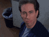 Seinfeld gif. Jerry Seinfeld looks at us coolly before his face breaks into an exaggerated shocked expression.
