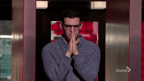 Reality TV gif. Kevin Martin on Big Brother Canada holds his hands up as if in prayer as he hopefully gazes out. 