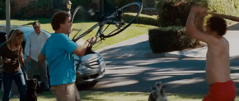 Movie gif. John C Reilly as Dale in Step Brothers attacks Will Ferrell as Brennan with a baseball bat as Brennan tries defending himself with a bicycle.