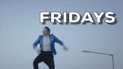 Video gif. A low-angle shot of Psy doing a hopping dance in a shiny blue jacket under a cloudy sky. Text, "Friday."