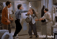 Seinfeld gif. Julia Louis-Dreyfus as Elaine jumps into Jerry's arms as she enters his apartment, then runs to Jason Alexander as George and Michael Richards as Kramer to hug them.