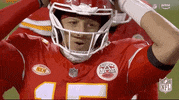 Sports gif. Slow motion clip of Patrick Mahomes of the Kansas City Chiefs stands on the field with his hands on his head like he's disappointed or surprised.