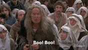 Movie gif. Margery Mason as The Ancient Booer from The Princess Bride, living up to her name as she yells at us angrily. Text, "Boo! Boo!"