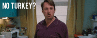 TV gif. David Mitchell as Mark in Peep Show. He's standing in the kitchen and looks livid as he says through gritted teeth, "No turkey?!"