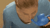 Video gif. A woman holds a neti pot up to her nostril and tilts her head. Water pours out the other nostril. 