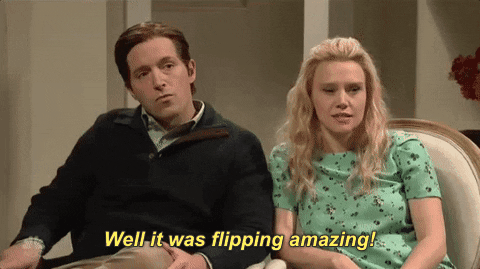SNL gif. Beck Bennett and Kate McKinnon sit next to each other, dressed like a normal straight couple. Beck has an annoyed expression on his face as he sarcastically says, “Well it was flipping amazing!” Kate looks over at him, trying to face a smile.