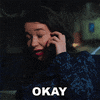 TV gif. Sarah Steele as Marissa Gold in The Good Fight, cell phone to her ear, eyes closed as if pain, shakes her head apprehensively, but willingly says, "Okay."