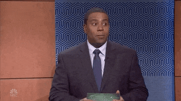 SNL gif. Kenan Thompson as a game show host wears a blue suit as he glances to the side, pausing for a beat before looking down at his cards uncomfortably and saying, "Okay."
