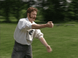 Late Night gif. Conan O'Brien wearing an old-timey baseball uniform complete with muttonchops and handlebar mustache, rounding punches in the air, trying to start a fight.