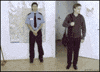 Video gif. A collection of videos of people using clever ways to camouflage themselves in an office. One pulls a map down over his head that turns into a table, while another pretends to be a plant, then another man hides under his desk. A man grabs a rope and shoots toward the ceiling while another man backs into a storage cabinet. Two people with a perfect replica of a whiteboard on their backs turn towards the whiteboard and disappear, then a man crouches into a chest.