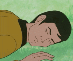 Cartoon gif. We zoom out on Spock in Star Trek: The Animated Series as he lies still while sleeping in the grass. 