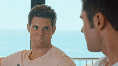 Movie gif. Adam DeVine and Zac Efron in Mike and Dave Need Wedding Dates glare at each other with intense and focused eyes. They give each other a powerful and forceful high-five. 