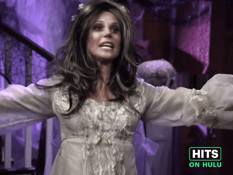Sponsored GIF. Julie Bowen, dressed in a corpse-bride style Halloween costume, is at her wit's end and dramatically pleads, "but it's MY crazy holiday," gesturing to herself.