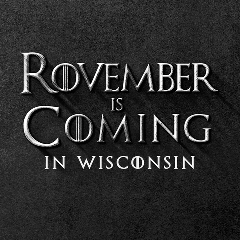 Text gif. In gray Game of Thrones font against a stony black background reads the message, “Rovember is Coming in Wisconsin.”
