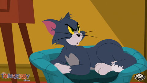 Cartoon gif. Tom from Tom and Jerry is laying in his bed but he's clearly upset at someone, as he furrows his brow and blows a raspberry in their direction.