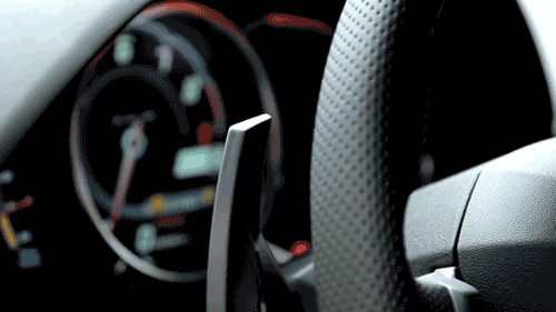 Video gif. We see part of a stylish, textured gray steering wheel before focusing on the sleek speedometer that jumps from zero to eight.