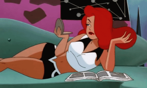 Cartoon gif. Poison Ivy lounges on a chaise as she looks in a compact mirror and fluffs her fiery red hair.