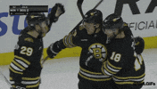 Sports gif. David Pastrnak of the Boston Bruins celebrating with his arms around his teammates, Parker Wotherspoon and Pavel Zacha.