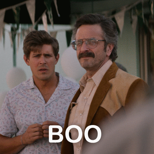 TV gif. Actors Marc Maron and Chris Lowell of GLOW in an outdoor scene. Marc Maron offers an impassioned "Boo!"