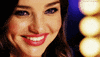 Celebrity gif. Close up on Miranda Kerr's face as she smiles and winks.