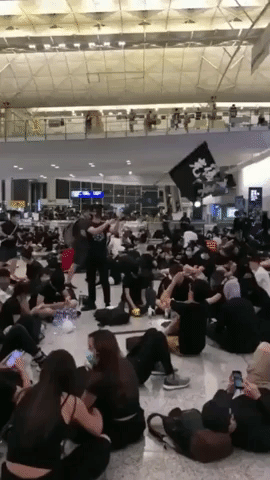 Protester Waves 'Reclaim Hong Kong' Flag as Demonstrators Shut Down Airport