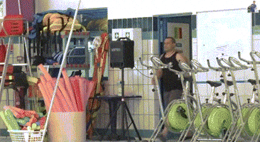 Video gif. Man enters the room to look in an empty indoor swimming pool that has a red stuffed fish flopping around in it. The man stands there with his hands on his hips, confused. He then turns around and leaves.