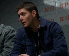 Dean Winchester seated, slowly facepalming